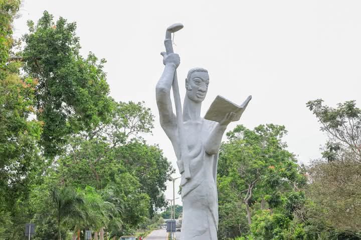 A statue holding book in hand