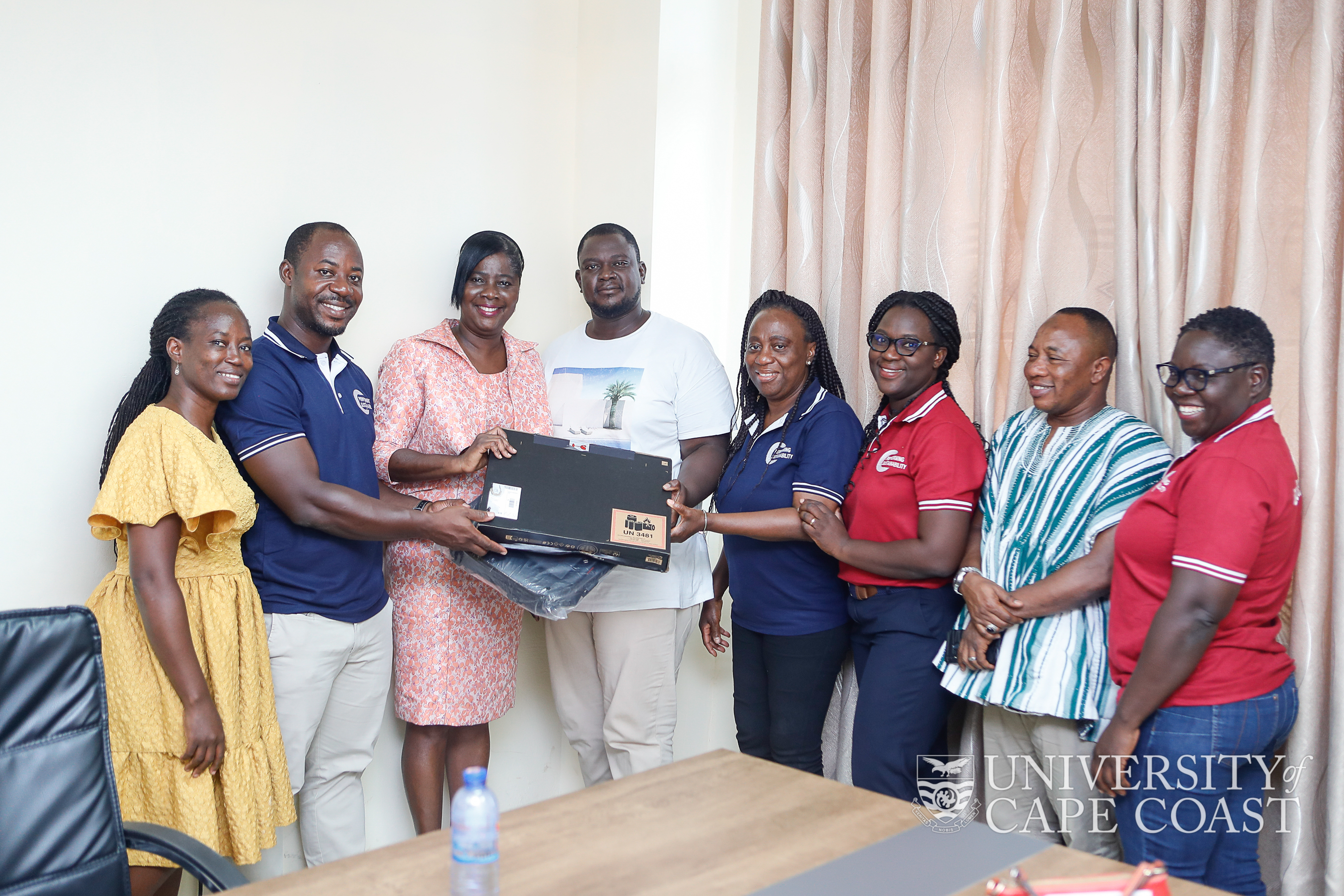 Presentation of laptop to a scholarship holder