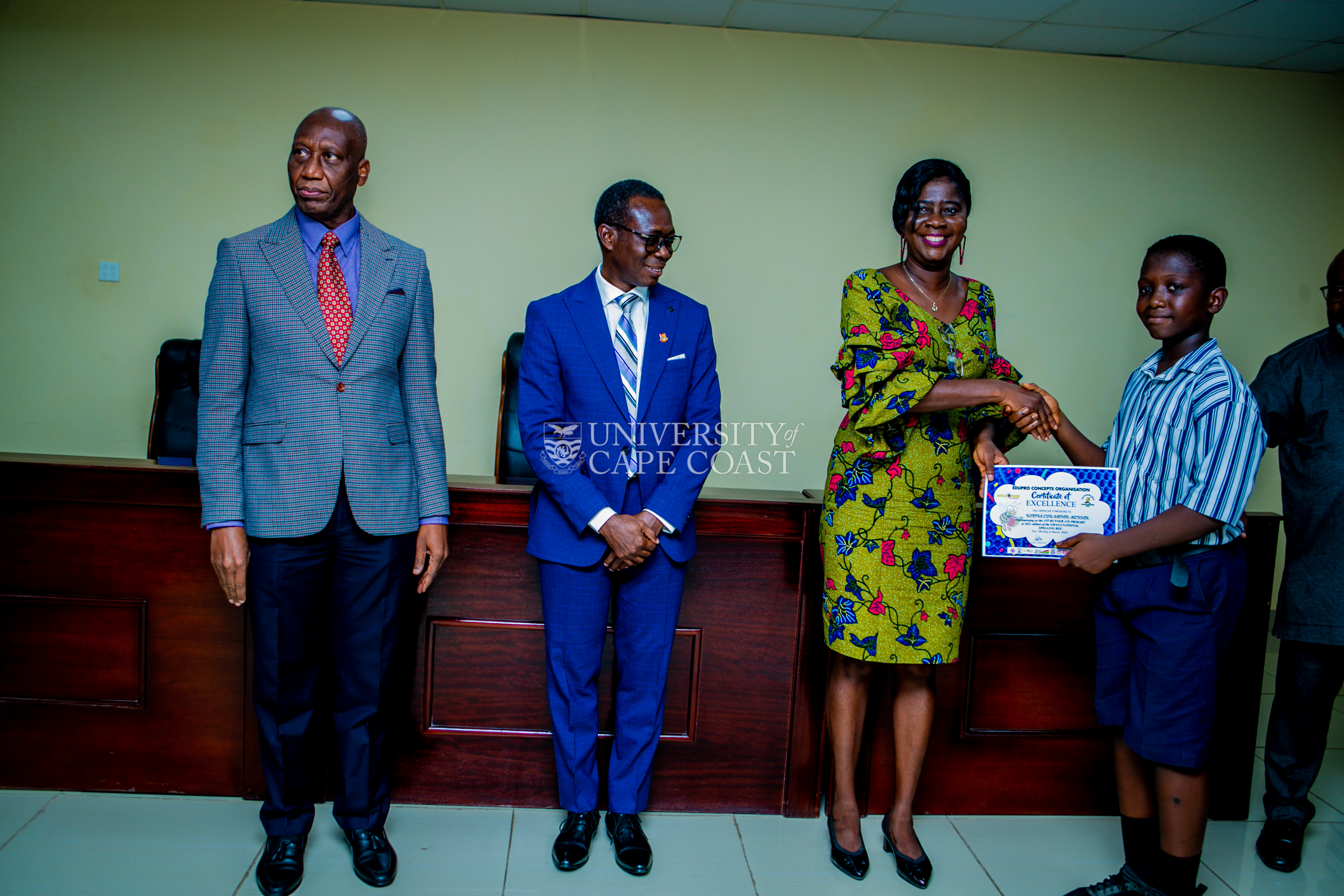 An award winner in a handshake with Pro VC-UCC, Prof. Rosemond Boohene. Looking on are the Vice-Chancellor (middle) and Registrar, Mr.Jeff Onyame (left)