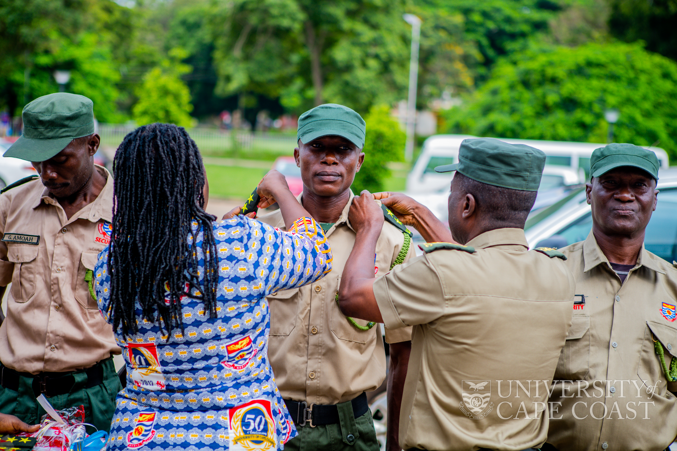 Mrs Graham(left) decorating a promoted security personnel at maiden Rank Wearing Ceremony