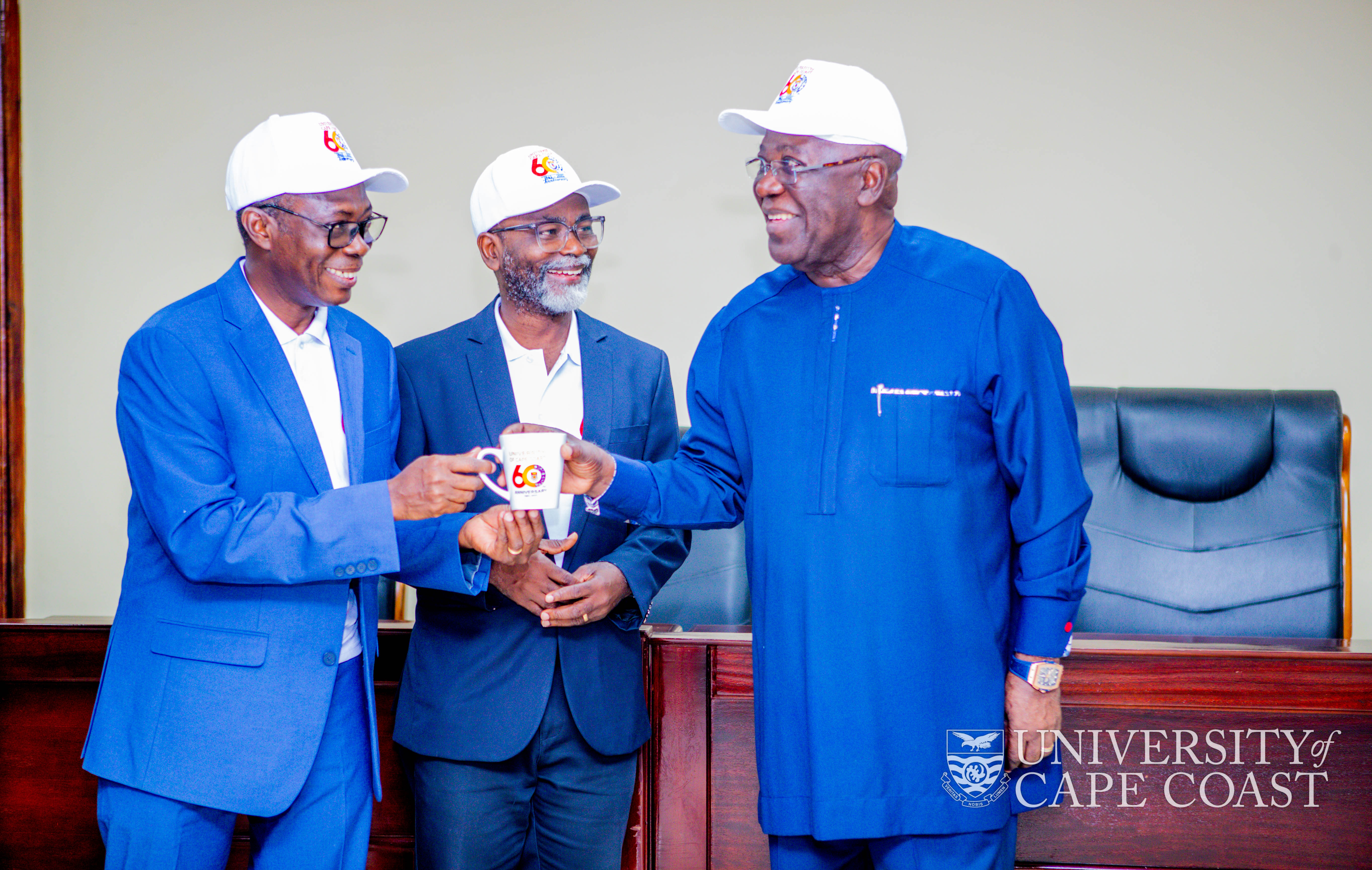 VC-UCC, Prof Boampong (left) presenting some UCC@60 Souvenirs to Dr. Jonah. Looking on is Prof Sam Amoah, Chairman UCC@60 Planning Committee