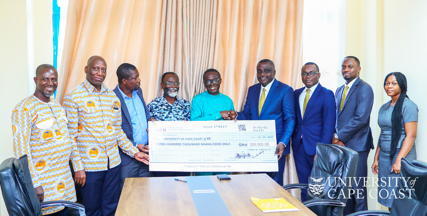 UCC officials receiving the dummy cheque from GCB-bank delegation.