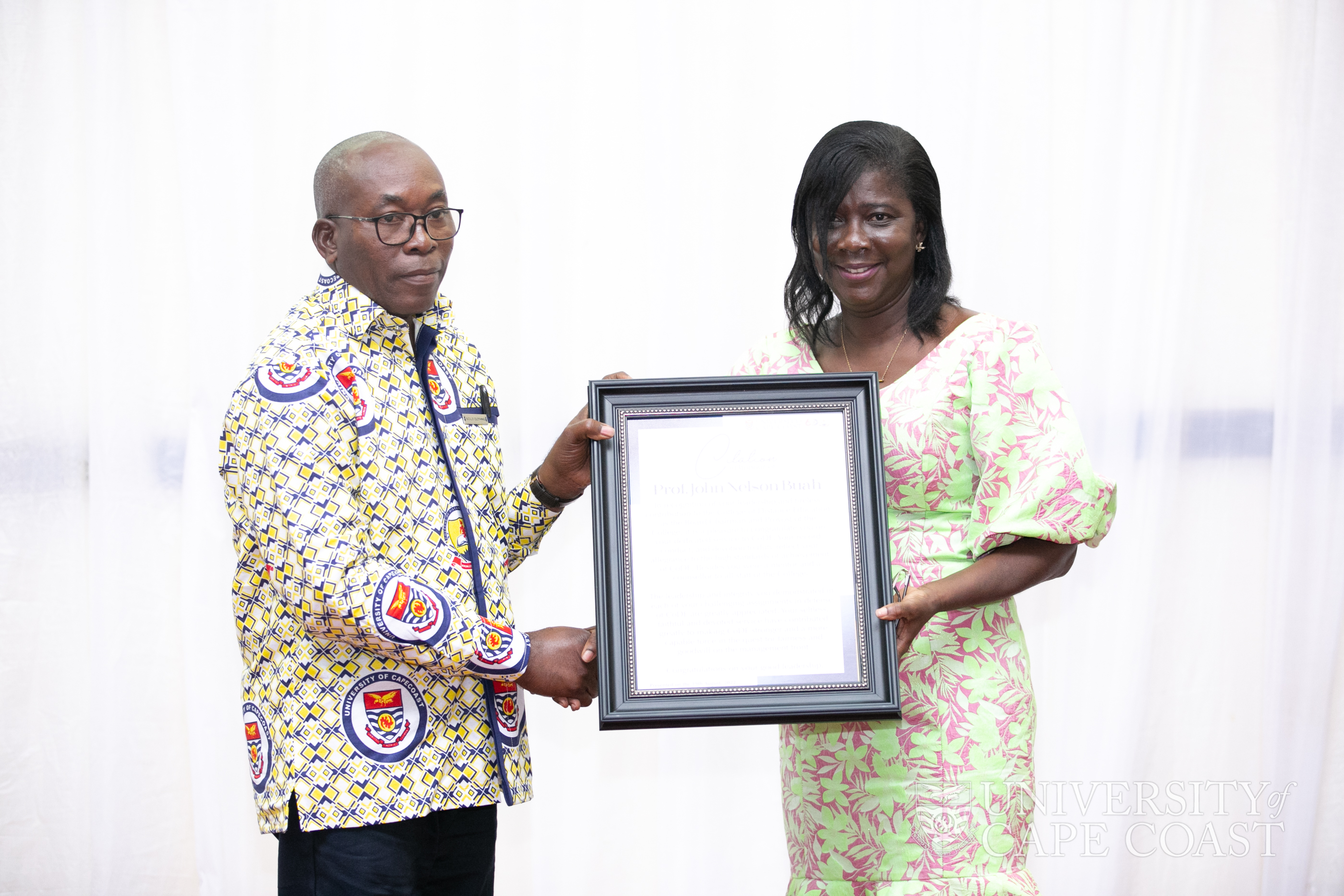 Former Ag. Provost of CoDE, Prof. Nelson Buah, receiving a citation of honour from Pro VC-UCC, Prof. Rosemond Boohene