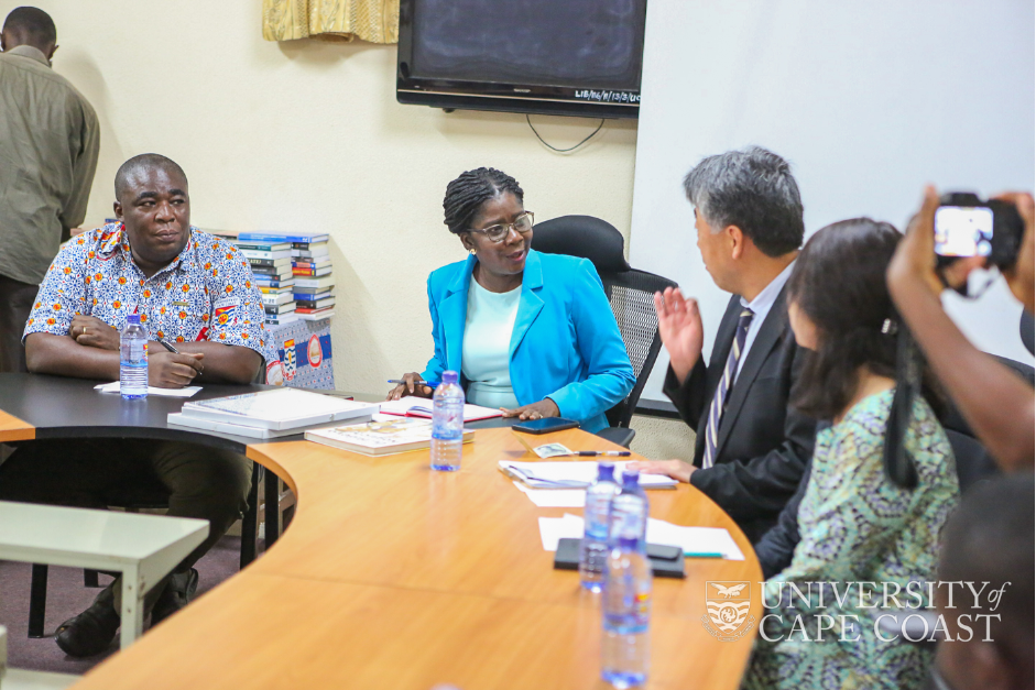 Pro VC-UCC, Prof. Boohene (in blue) interacting with the Deputy Head of Mission at the Japan Embassy in Ghana, Mr. Nuoki MIITORI. Looking on is Dr. Mac-Anthony Cobblah, the University Librarian