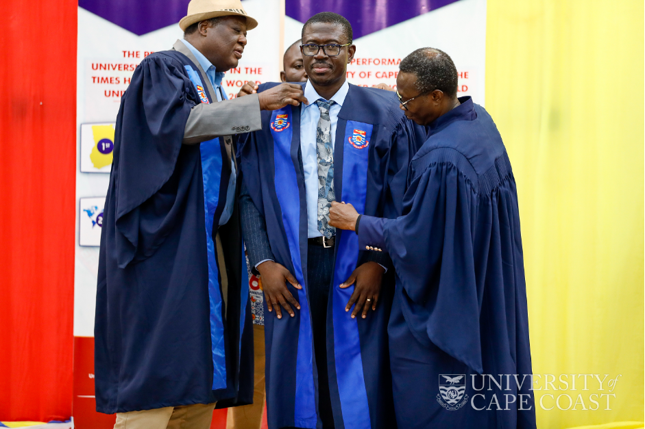 Prof. Ishmael Mensah being robed after his inaugural lecture by the VC-UCC, Prof Nyarko Boampong (right) and Prof. Machiste Abane (left) both members of the College of Professors UCC