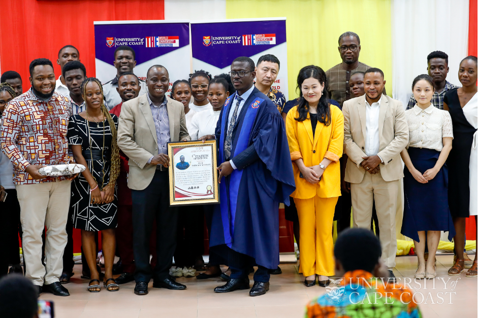 Prof. Mensah receiving a citation from the Ghana Director of the Confucius Institute-UCC (CIUCC), Prof. Emmanuel Amo Ofori with staff of the institute. Also on the stage is Prof. Ou Yamei, China Director of CIUCC (in yellow)