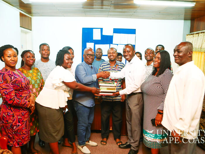 Group of people handing over books