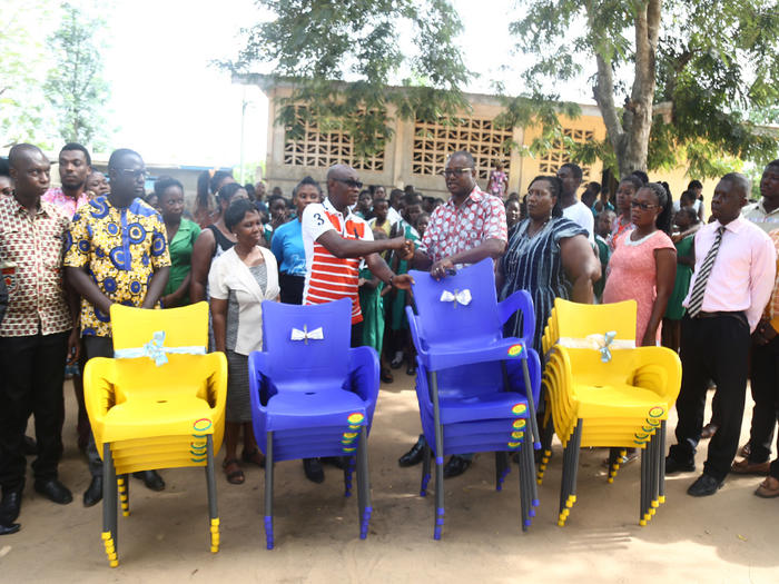 Prof. Sampson Nyarko-Sampson presenting the chairs to the headteacher of the School