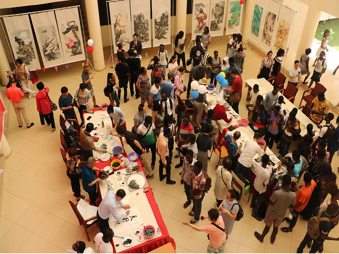 Some of the Chinese artistes painting at their  at the programme
