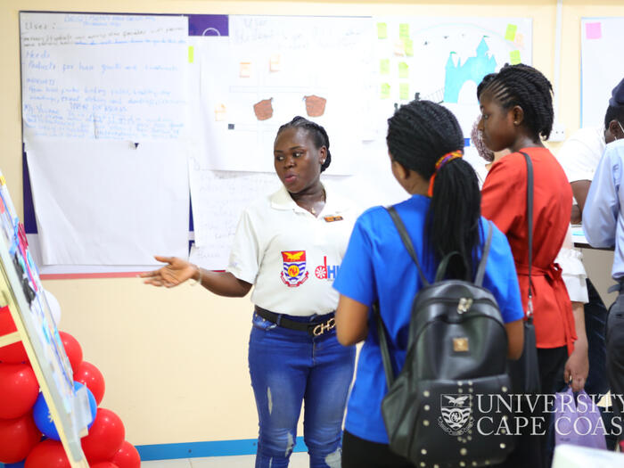 A staff member explaining a point to student entrepreneurs.