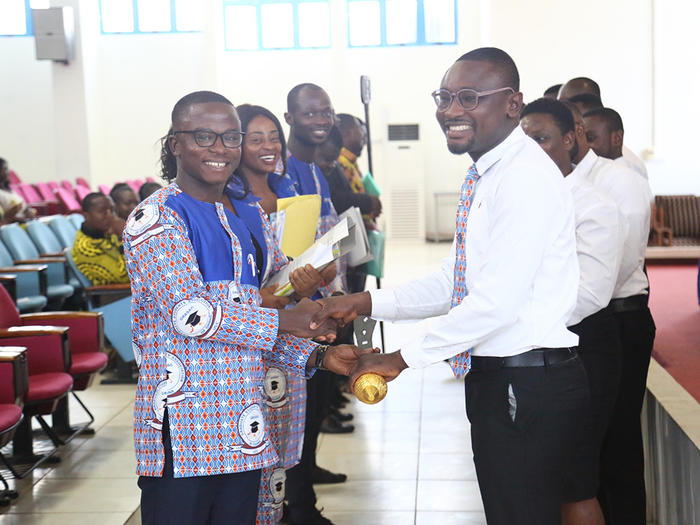 The New GRASAG President, Mr. Albert Awortwi Sagoe, receiving the symbol of office from Mr. Geoge Sarfo, the immediate past GRASAG President