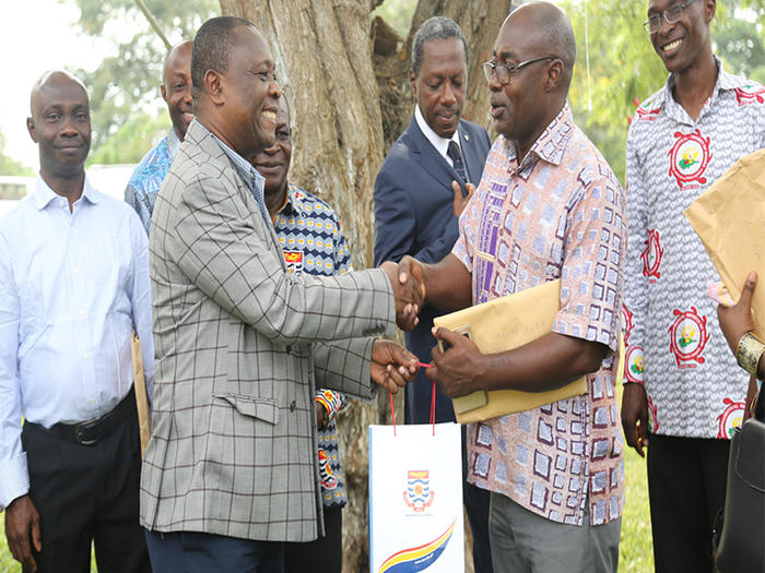 Prof. Oduro presenting UCC branded souvenir to the leader of the Ghana Medical and Dental Council delegation 